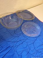 All three glass items displayed on blue surface