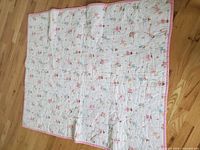 Full view of reverse side showing white ground with small ballerina print and pink binding