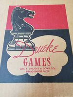 Drueke Games logo on cardboard lid