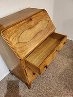 Front view with lower drawer open showing wood grain and hardware