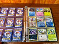 Album open showing nine card backs and eight card fronts