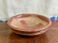 Oblique view of red clay bowl exterior and interior color