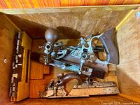 Plane body, rosewood handle, knob, attached fence and depth stop inside case with cutters and rods visible