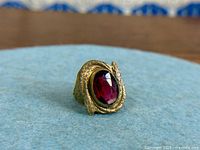 Front view of ring showing snake motif and red stone