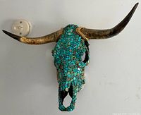 Front view of steer skull with turquoise mosaic and horns