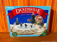 Front of box showing Dickensville Animated Skating Pond branding and scene