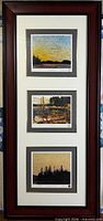Full view of tall wood frame with three matted prints