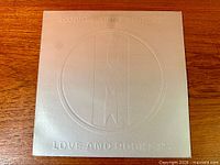Full front view of embossed silver sleeve