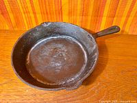 Top view of cast iron skillet showing interior surface and pour spout