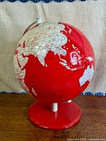 Front view of red globe on stand