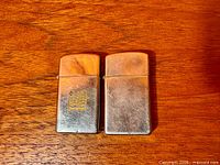 Front view of both Zippo Slimline lighters, logo visible on left unit