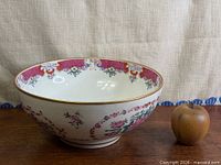 Full view of punch bowl with apple for scale