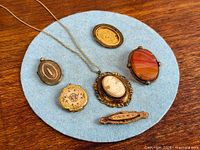 Group shot showing all six jewelry pieces on blue felt