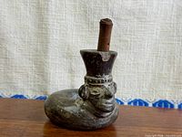 Full view of vessel showing head, body loop, and wooden dowel