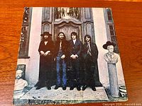 Front album cover showing Beatles standing at doorway