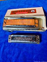Koch harmonica in box and Bugle Band harmonica displayed