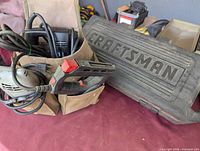 Overview of tools inside canvas pouch next to Craftsman case