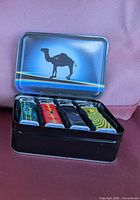 Tin open showing four lighters inside