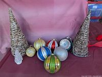 Group shot showing cone trees and eight large plastic ornaments