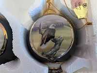 Close-up of one ornament showing eagle artwork and tag