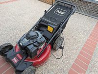 Front angle of Toro mower showing engine, deck, wheels, handle