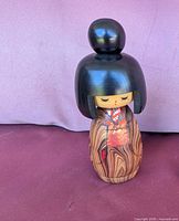 Front view of wooden Kokeshi geisha doll