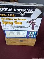 Central Pneumatic HVLP spray gun box atop router bit wooden case