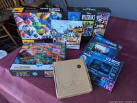 Group shot of all puzzles, LED strip light boxes and solar fountain box