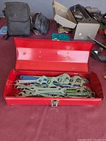 Toolbox open showing assortment of wrenches