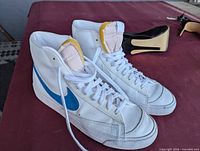 White Nike high-top sneakers front and side view