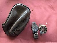 Overall lot showing both watches and pouch