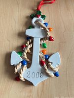 Front view of ceramic anchor ornament showing 2006 date and multicolour lights
