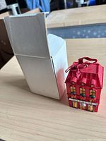 Ornament and box side by side showing scale and design
