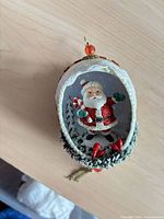 Front view showing Santa scene inside glass ornament