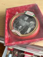 Ornament in its original red window box showing film still and tags