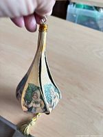 Full view of drop-shaped ornament showing printed Victorian children and glitter finish