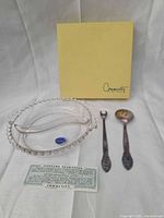 All items laid out: beaded rim dish, tongs, spoon, fork, box, guarantee card