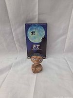 Front view of figurine with VHS sleeve