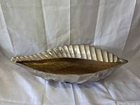 Top view showing shell shape, silver exterior, gold interior