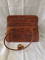 Front view showing tooled design and handles