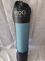 Rolled mat inside branded PIDO carry bag