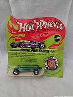 Front of sealed blister card showing car, button, graphics