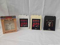 Front view showing Alive II slipcase, two Alive II cartridges, Gene Simmons cartridge