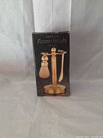 Front of boxed solid brass razor/brush set