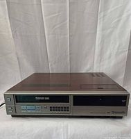 Front left angled view of Panasonic PV-1225 VCR showing cabinet finish and overall condition