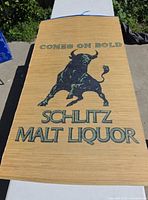 Full view of woven sign on table showing entire design and text