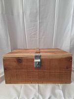 Closed wooden box showing front and hasp latch