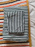 Folded duvet cover and sham displaying stripe pattern