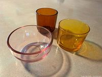 Three colored glass tealight holders grouped on surface