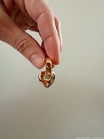 Close-up showing clasp and Pilgrim stamp on one earring